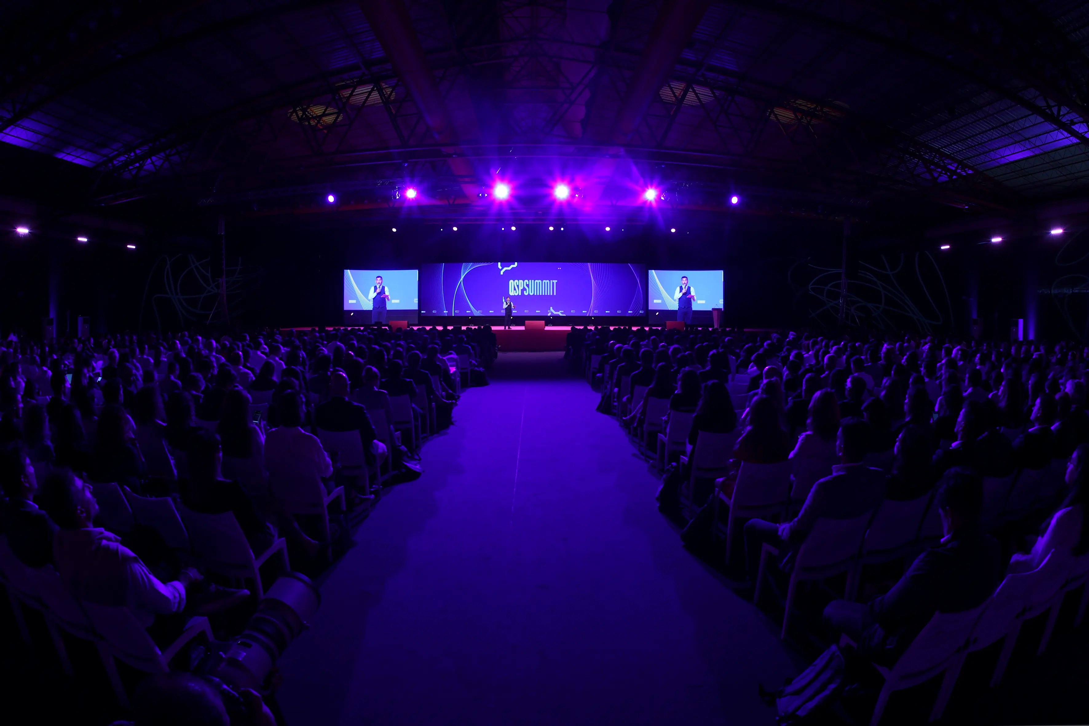 Keynote speaker presenting to a full conference hall